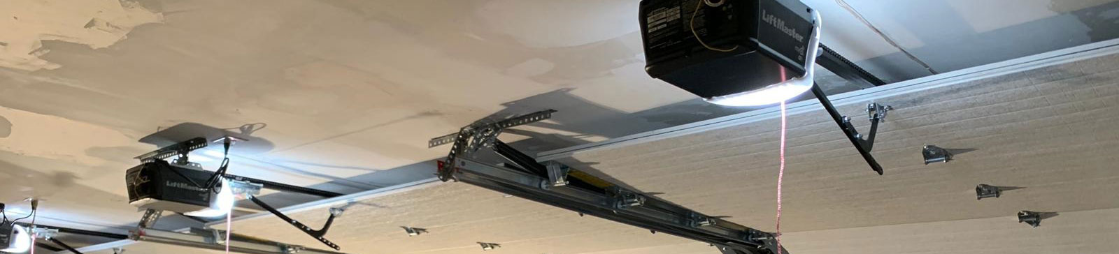 Fully installed white sectional automatic garage door on Daly City residential garage