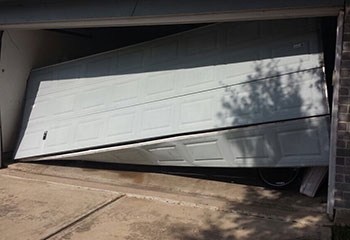 Garage door severely off its tracks needing urgent repair at Daly City home
