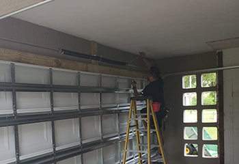 Garage Door Repair Daly City technician performing garage door spring installation in residential garage