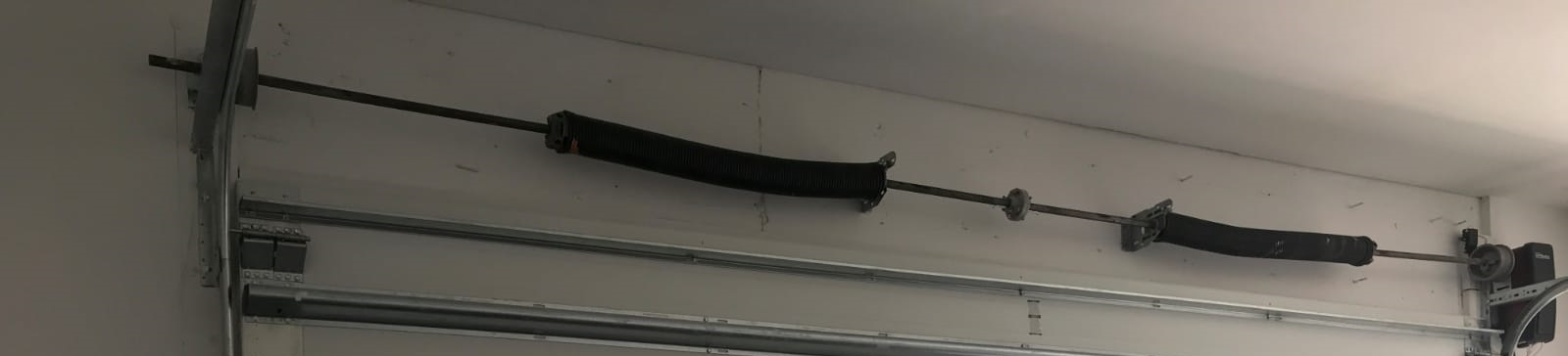 Garage Door Repair Daly City technician performing garage door spring installation in residential garage